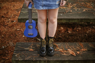 Low section of woman standing on wood