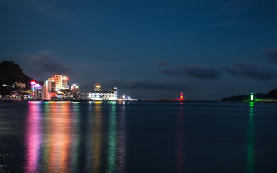 Illuminated city at waterfront