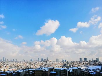 Panoramic view of buildings in city against sky