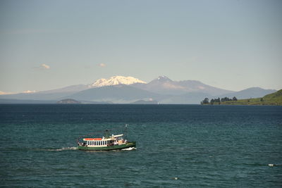 Boat sailing in sea against sky