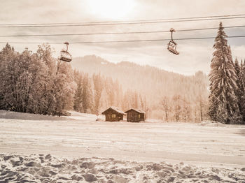 Scenic view of snowcapped field against sky