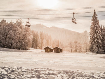 Scenic winter snow scene with chairlift and huts