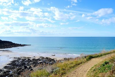 View of calm beach against blue sky