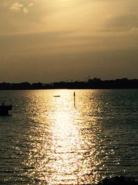 Scenic view of river at sunset