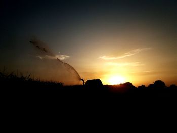 Silhouette landscape against sky during sunset