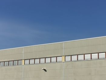 Low angle view of building against clear blue sky