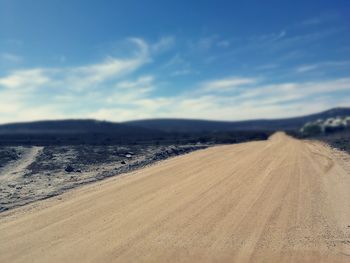 Scenic view of land road against sky