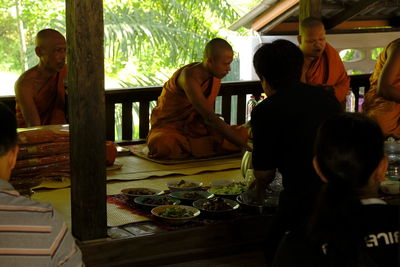 Rear view of people sitting at table