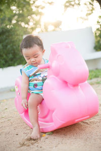 Cute boy sitting on toy