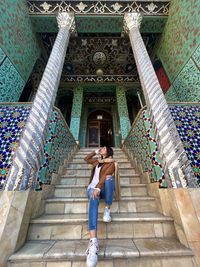 Rear view of woman walking on staircase