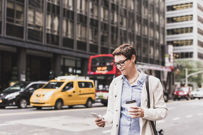 Man standing on street in city