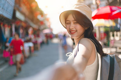 Portrait of smiling young woman in park