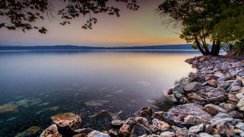 Scenic view of lake at sunset