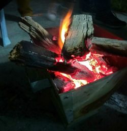 Close-up of bonfire on wood at night