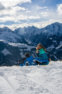 Tourists on snow covered mountain