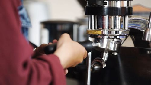 Close-up of hand holding machine