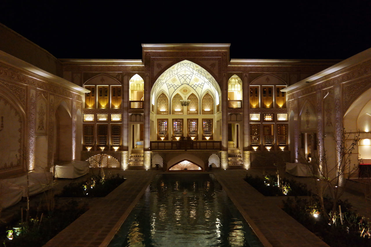 INTERIOR OF ILLUMINATED BUILDING AT NIGHT