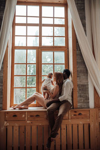 Couple sitting by window