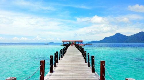 Pier over sea against sky