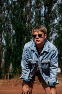Portrait of young man wearing sunglasses standing outdoors