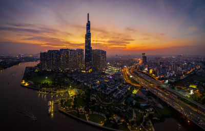 High angle view of illuminated city buildings during sunset