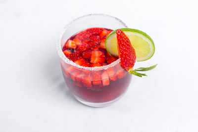 High angle view of fruits in glass over white background