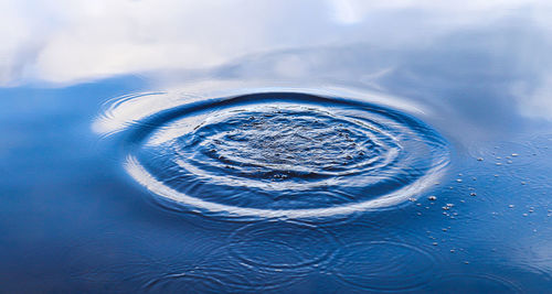 Digital composite image of rippled water against blue sky