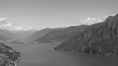 Scenic view of lake by mountains against sky