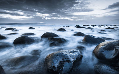 Portugal coast ocean vaction water flowing stones rocks perspective dramatic sky surreal look