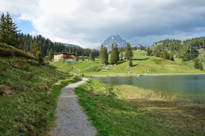 Hiking trail by the alpine lake hotel in austrian alps