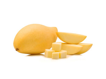 Close-up of mangoes against white background