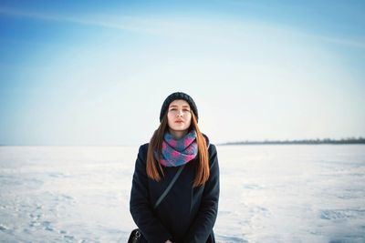 Portrait of young woman standing outdoors during winter