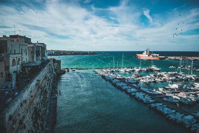 Panoramic view of sea and buildings against sky