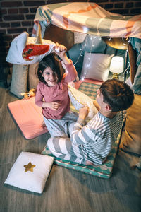 High angle view of mother and daughter on table