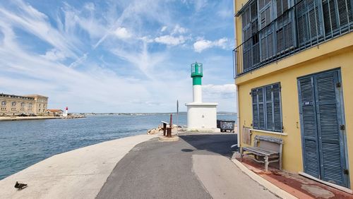 Buildings by sea against sky in city