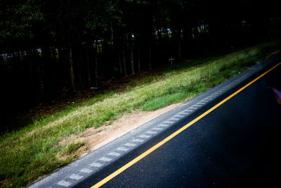 Empty road passing through forest