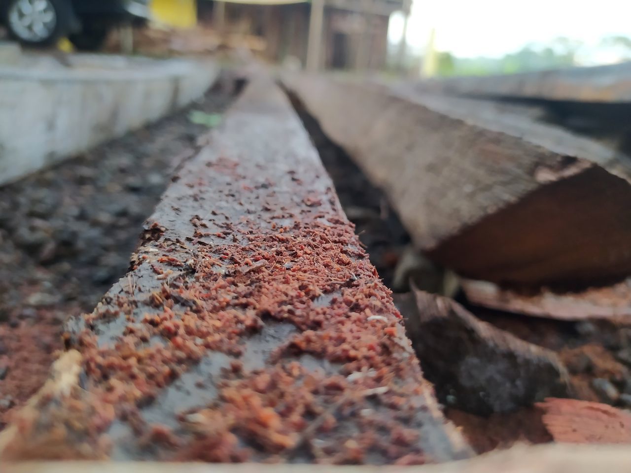 soil, selective focus, no people, industry, day, wood, close-up, transportation, rusty, nature, metal, outdoors, architecture, iron, focus on foreground, construction industry, track, vehicle