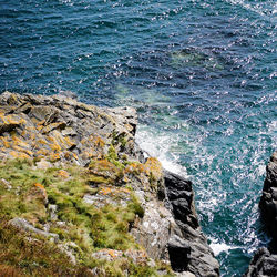 Scenic view of sea by rock formation