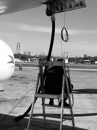 View of airplane in city against sky