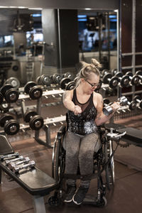 Woman on wheelchair training in gym