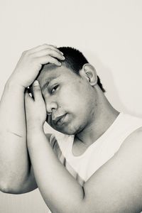 Portrait of young man against white background
