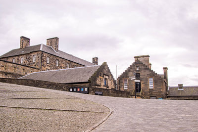 View of old building against cloudy sky