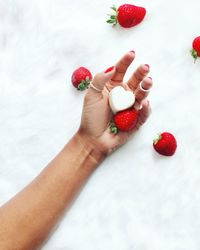 Close-up of hand holding strawberries