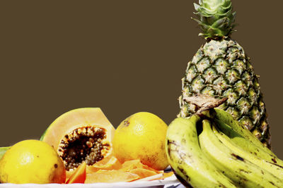 Close-up of fruits in plate against black background