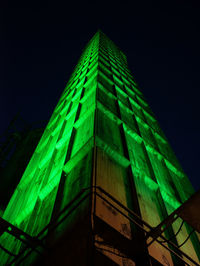 Low angle view of illuminated building against sky at night