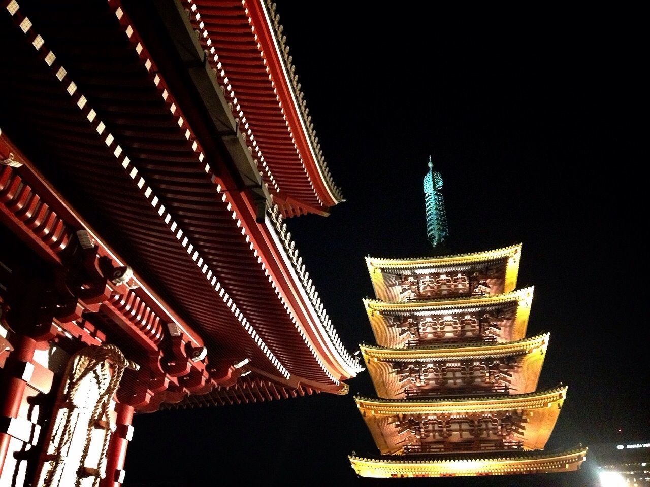 illuminated, low angle view, architecture, built structure, night, building exterior, lighting equipment, place of worship, religion, no people, sky, decoration, spirituality, city, famous place, building, outdoors, multi colored, clear sky, architectural feature