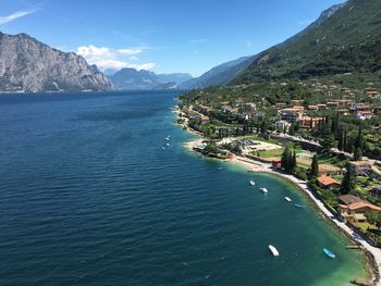 Scenic view of sea by city against sky
