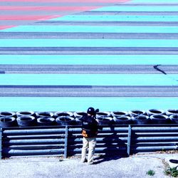 Rear view of man photographing sports track