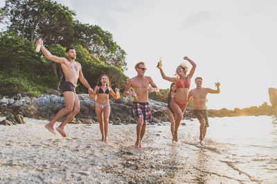 Friends enjoying at beach during summer