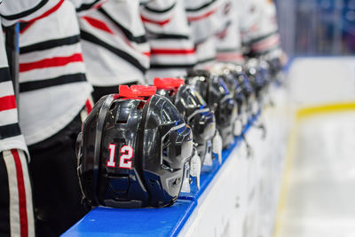 Close-up of helmets in row on table